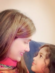 Dr. Anum Syed looking at her daughter