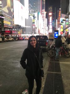 Dr. Tanvi Patel on the sidewalk in a big city at night time
