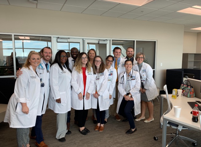 BH-UAMS Resident Group posing in white coats