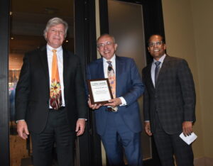 Dr. Stan Kellar and Dr. Prasad Padala present Dr. Erick Messias with an plaque to honor his dedication to the Baptist Health UAMS psychiatric department.