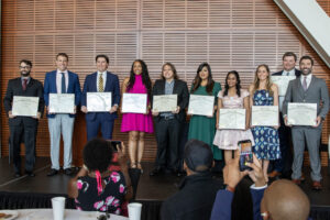 Family Medicine Residency Graduate stand together with their diplomas. 